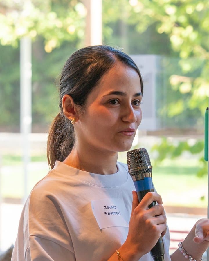Zeynep Savaseri, founder of HerCode, speaking at a HerCode event